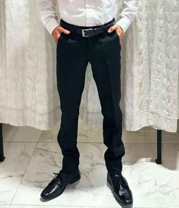 Hombre vistiendo pantalón de vestir negro ajustado slim fit con camisa blanca y cinto negro de sastrería juan